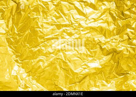 abstract textured yellow background made of wrinkled golden paper Stock Photo