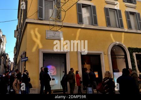 Rome, Italy - December 13th 2020: View of the Via dei Condotti during the Covid-19 epidemic. Many people who wear protective face masks on their Chris Stock Photo