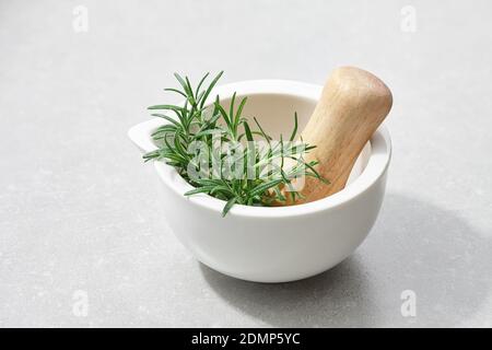 Fresh rosemary in mortar, close up view Stock Photo