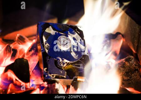 Crushed Hard Disk Drive in the Fire Stock Photo