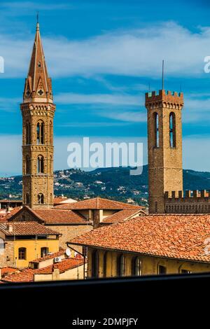 Splendid view of the bell tower of the Badìa Fiorentina and the Volognana Tower of the Palazzo del Bargello, poking out from the rooftops of Florence,... Stock Photo