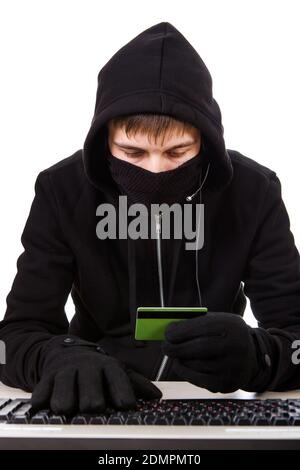 Hacker with a Bank Card and the Computer Keyboard on the White Background Stock Photo