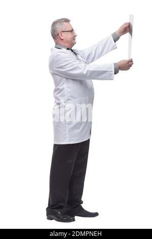 Doctor having a close look at x-ray image while holding it against light Stock Photo