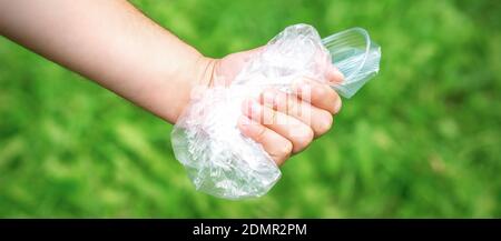 The person holds used crumpled plastic debris in his hand. Environmental problem concept. Stock Photo