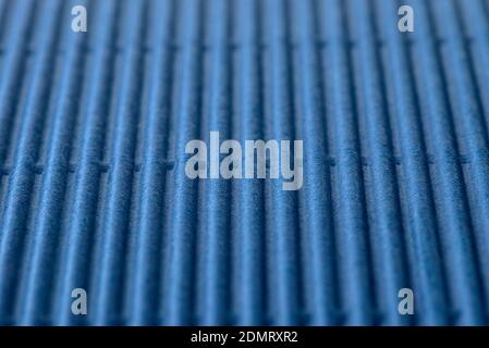 Background made of blue corrugated cardboard with vertical stripes, shallow depth of field. Stock Photo