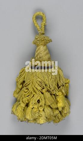Tassel, Medium: silk, wooden core, Skirt of yellow silk in two lengths, twisted and looped, and each supporting a tassel. Head is cylindrical and swelling toward the base, wrapped with yellow silk threads with collars of looped threads at top and bottom. Loop of yellow silk cord., Spain, 18th century, trimmings, Tassel Stock Photo