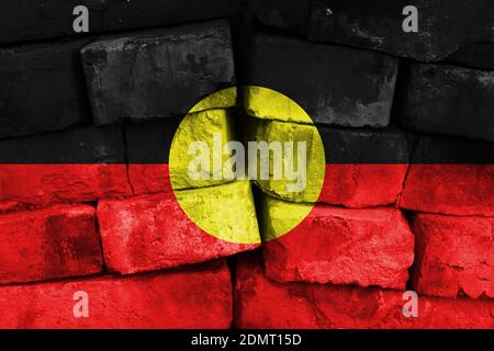 Australian Aboriginal flag painted on the cracked grunge concrete wall ...