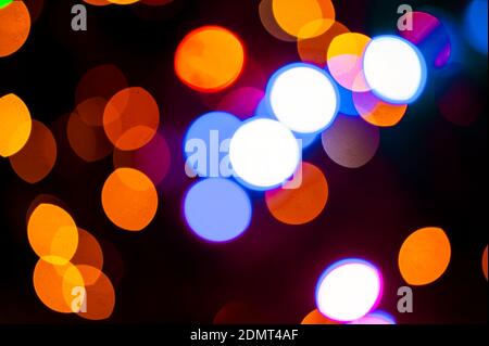 Blurred christmas lights bokeh abstract black background Stock Photo