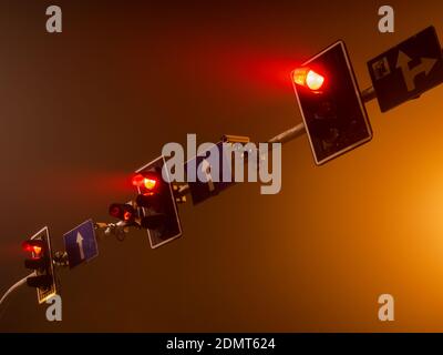 red light of traffic lights in a foggy night city Stock Photo