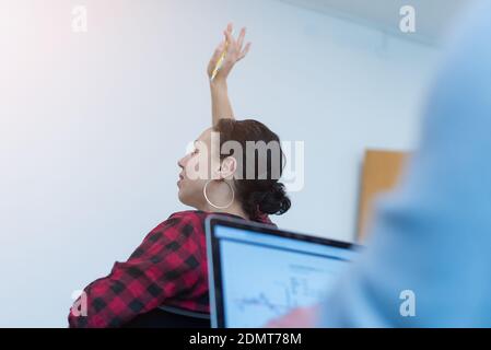 Young modern coworkers having a presentation about new marketing strategies on whiteboard Stock Photo