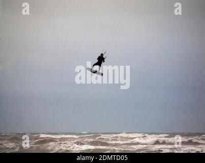 A kitesurfer out on a wet winter's day close to Brighton Stock Photo