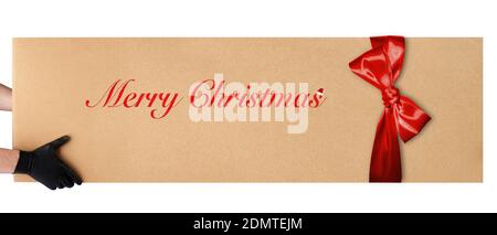 courier hands in black vinyl gloves hold a huge box with a red bow  Stock Photo