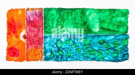 abstract colorful hand-coloured fabric in batik technique with salt spots ion white background Stock Photo