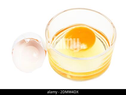 broken chicken egg in glass bowl and empty white shell isolated on white background Stock Photo