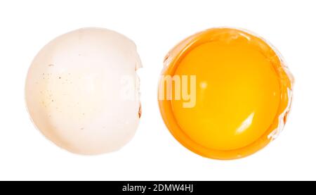 top view of separated egg yolk in shell and empty half of shell isolated on white background Stock Photo