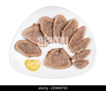 top view of sliced boiled beef tongue on white plate isolated on white background Stock Photo