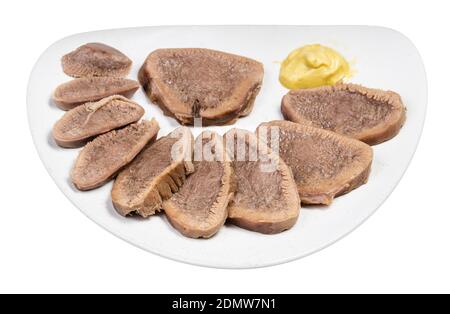 portion of sliced boiled beef tongue on white plate isolated on white background Stock Photo