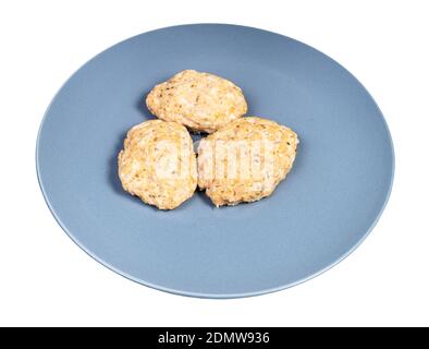 homemade steamed red fish cutlets on blue plate isolated on white background Stock Photo