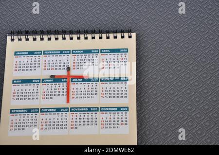 Calendar, on colored printed paper with the year 2020, with a cross made of red matchsticks, top-down photo, zoom photo, conceptual photo Stock Photo