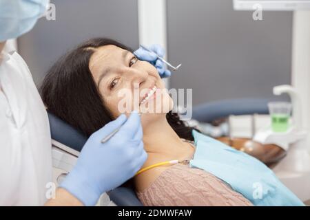 Healthy teeth. Beautiful senior woman smiling to the camera while on a dentist checkup at the clinic medical healthcare examination teeth toothy smile Stock Photo