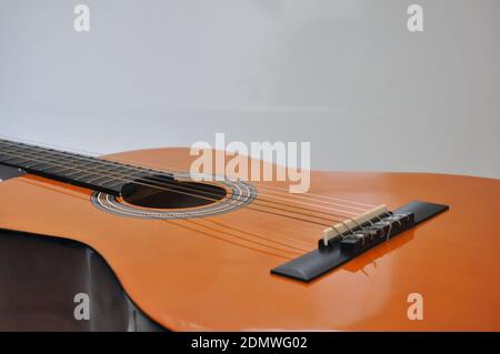 Guitar. Saddle, bridge, bridge pins, Details of a guitar part, nylon or steel strings, on white background, Brazil, South America, side view Stock Photo