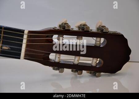 Tuning Key. Detail of a part of a guitar, with zoom photo, nylon or steel strings, on white background, Brazil, South America Stock Photo