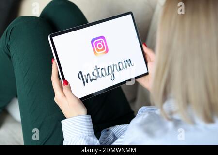 Woman holding tablet with instagram inscription closeup Stock Photo