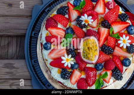 Anna Pavlova French dessert with blackberries,blueberries, passion fruit, raspberries, strawberries. Meringue cake. Vegetarian cake. Low fat dessert. Stock Photo