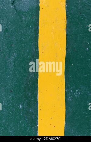 Abstract yellow painted line on a green background Stock Photo