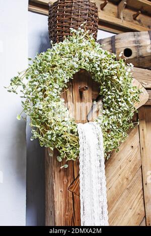Easter wreath on wooden door. Spring home decorations. Stock Photo