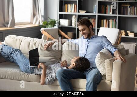 Happy couple rest at home using computer Stock Photo