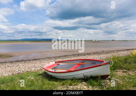 Lancaster, Lancashire, England. View across the estuary of the River Lune off Sunderland Point at low tide, small boat on shore. Stock Photo