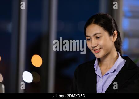 Portrait business young woman working overtime late at night in call center office. Concept for business at night. Stock Photo