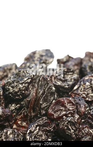 Extreme close up picture of small seedless raisins isolated on white background, selective focus. Stock Photo