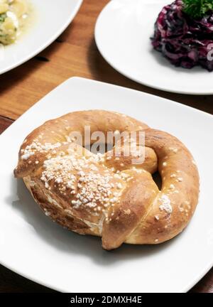 vegan dairy-free organic german traditional pretzel bread on wood table Stock Photo