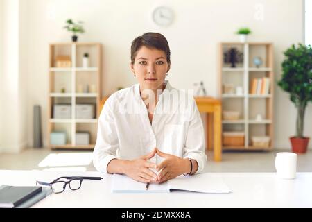 Young business woman explaining something during online meeting Stock Photo