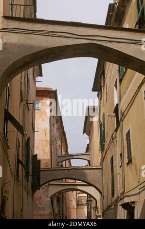Typical lane called carrugio with stairs and arches in Finalborgo, Liguria, Italy Stock Photo