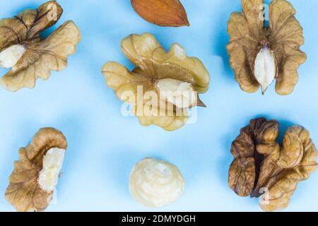 Nuts, walnuts, almonds and hazelnuts on a blue background, macro image Stock Photo