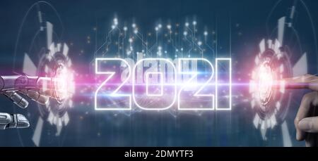 2021 futuristic tehcnology trend concept,  hand man and robot hand pointing together in concept futuristic in 2021 coming year the year of artificial Stock Photo