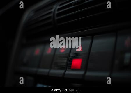 Emergency button highlighted in red on the instrument panel close up Stock Photo