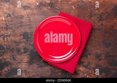 Empty ceramic red plate on brown wooden background Copy space Top view - Image Stock Photo
