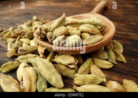 Сardamom spice bunch on wooden table macro Stock Photo