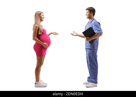 Full length profile shot of a doctor in a blue uniform having a conversation with a young pregnant woman isolated on white background Stock Photo