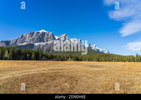 Quarry Lake Park, serene mountainside beach and dog park in late autumn season sunny day morning. Snow capped Mount Rundle with blue sky