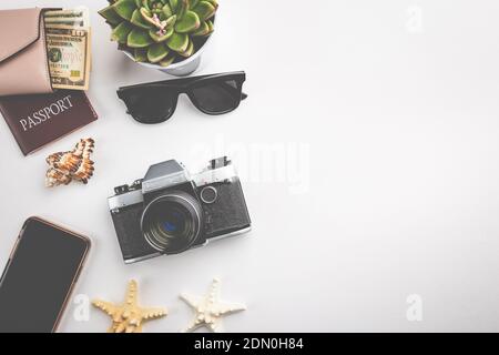 Summer holiday flat lay, top view travel concept with retro camera, sunglasses, passport and wallet on white background Stock Photo