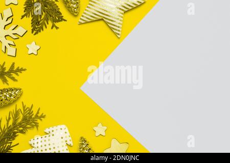 Christmas frame with baubles, decorations on Illuminating Yellow and Ultimate Gray background. Creative design demonstrating colors of the year 2021 Stock Photo