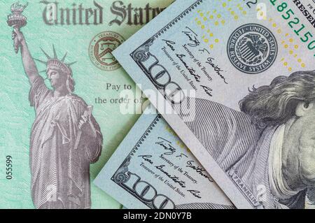 Tax Refund Check with Hundred Dollar Bills. Stock Photo