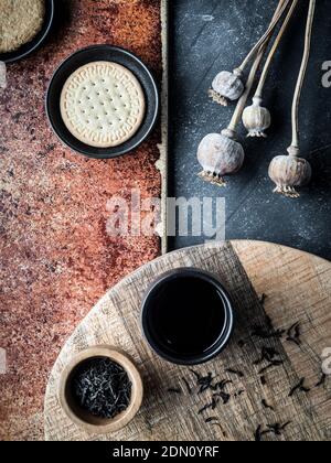 Different types of cookies and cup of cofee on grey and teracota background. Overhead shot. Stock Photo