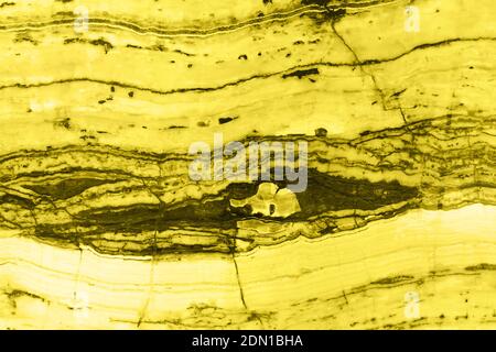 Natural marble texture toned in trendy yellow for background or backdrop. Color 2021 concept. Interior marble stone design. Stock Photo