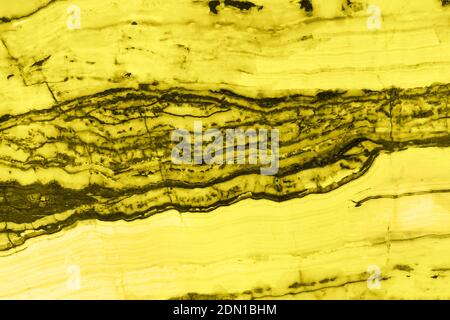 Natural marble texture toned in trendy yellow for background or backdrop. Color 2021 concept. Interior marble stone design. Stock Photo